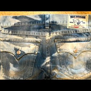 A pair of gently used True Religion blue jeans.